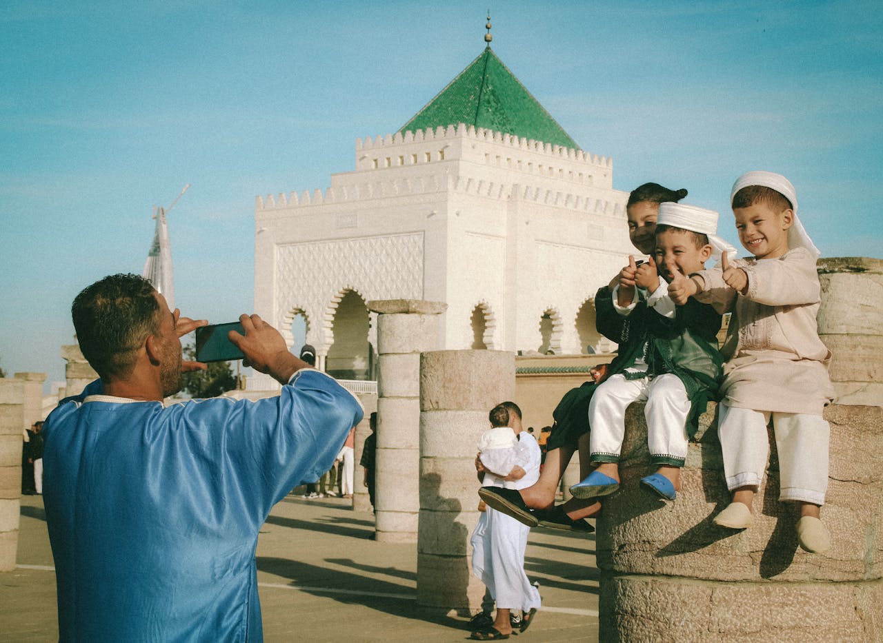 Mastering the First Impression: Your intriguing post title goes here Children in traditional attire pose for a photo at Mohamed V Mausoleum in Rabat, Morocco.